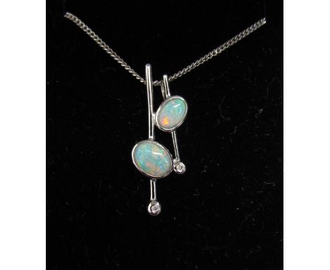 A white gold opal and diamond pendant stamped 9k hung on a 9ct white gold chain, 40cm long, 4g