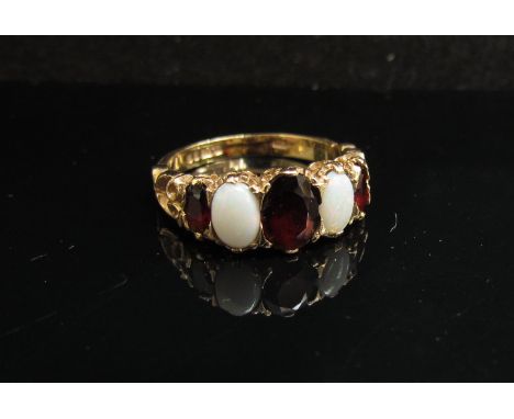 A 9ct gold five stone garnet and opal ring. Size N, 3.1g