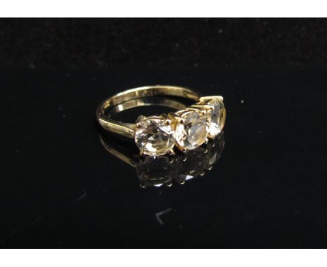 A 9ct gold Serenite three stone ring. Size N/O, 2.3g with certificate