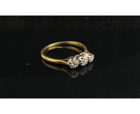 A gold three stone diamond ring, unmarked. Size O, 1.6g