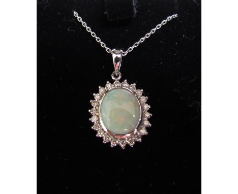 A white gold opal and diamond pendant stamped 8ct hung on a white gold neckchain, 40cm long, stamped 750, 4.3g