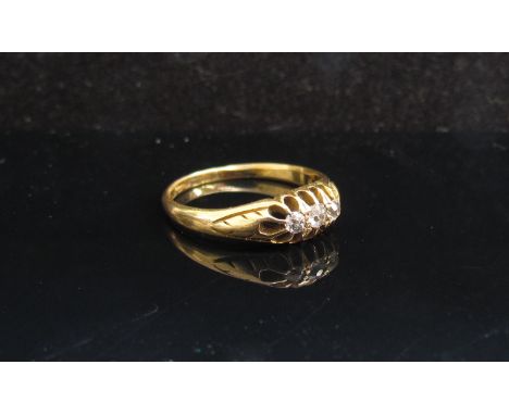 An 18ct gold ring set with three old cut diamonds. Size K, 2.4g