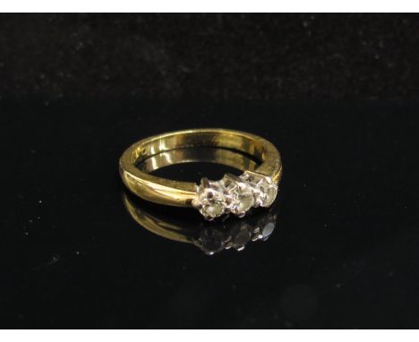 An 18ct gold diamond ring set with three diamonds. Size L, 3.4g