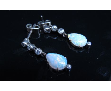 A pair of pear shaped opal and four diamond drop earrings, boxed with 1960's receipt, 2.8cm drop