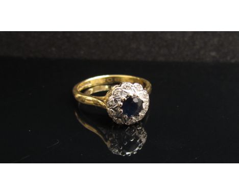 An 18ct gold sapphire and diamond cluster ring. Size N/O, 3.9g