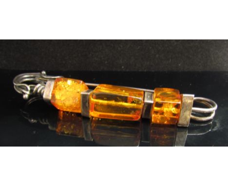 A silver and amber kilt/scarf pin