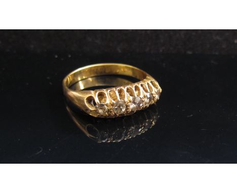 A gold ring set with five graduated old cut diamonds in open claw setting. Size Q, 4.1g