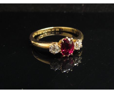 An 18ct gold ruby and diamond dress ring in claw setting. Size Q, 3.2g