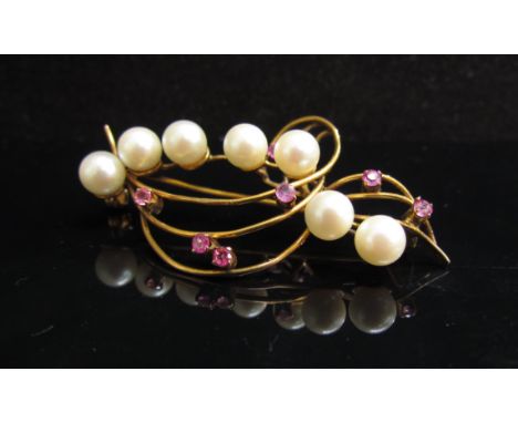 A gold cultured pearl and ruby set spray brooch stamped 14k, 5.5cm long, 7.1g