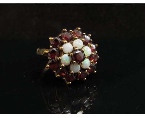 A 9ct gold opal and garnet cluster ring. Size L, 5.7g