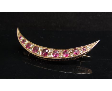 A Victorian gold ruby and diamond crescent brooch, the nine graduating rubies interspersed with eighteen small diamonds, unma