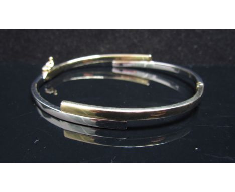 A two tone gold bangle stamped 375, 7.5g