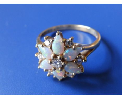 An opal & diamond flowerhead cluster ring on 18ct yellow gold shank