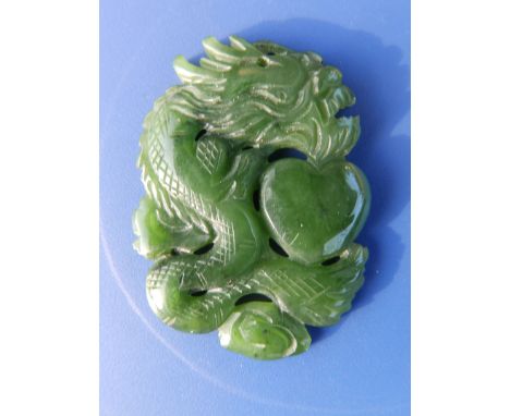 A Chinese jade coloured dragon and heart pendant