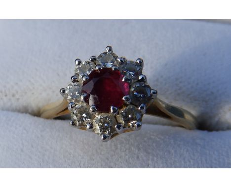 A ruby & diamond cluster ring on 18ct yellow gold shank