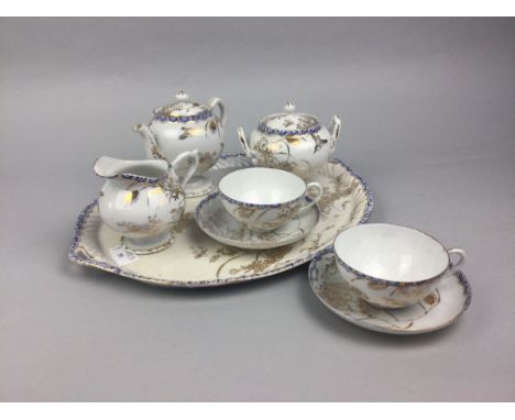 CHINESE CERAMIC TEA FOR TWO SERVICE, decorated with flying birds and flowering foliage in gilt, on a white ground, comprising