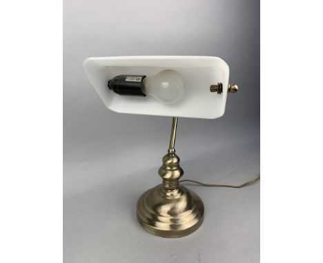 BRASS DESK LAMP, with opaque glass shade, along with a pair of wooden lady tricyclists and a standing figure of a gentleman (