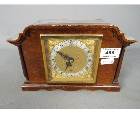 An Elliott mantel clock, brass dial with Roman numerals to a silvered chapter ring.