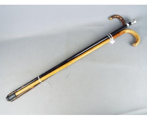 A walking stick with 9ct rose gold collar, a silver topped walking stick and one other.