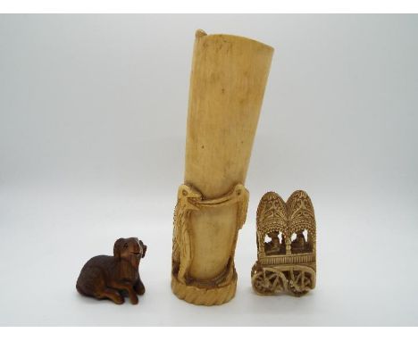 A Japanese carved wood netsuke in the form of a goat, signed, a bone vase with depiction of animals and other.