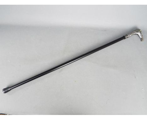 A walking stick with eagle head handle and green eyes