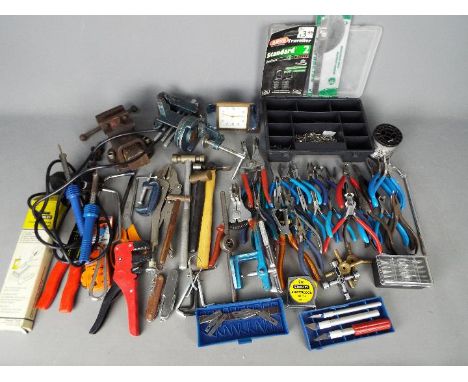 A collection of tools to include some watchmakers tools.