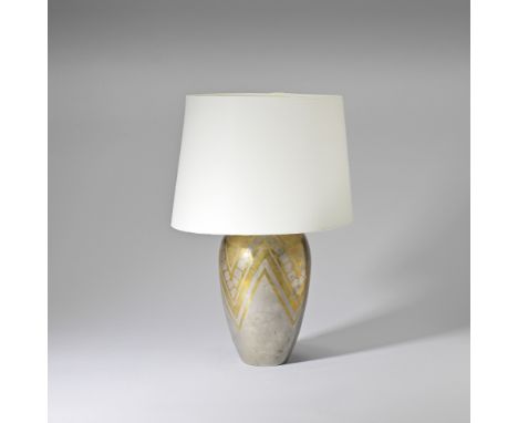 J. RudelleDinanderie table lamp, circa 1925Mixed metal with geometric design, fabric shade.41.7 cm high Base signed 'J. Rudel