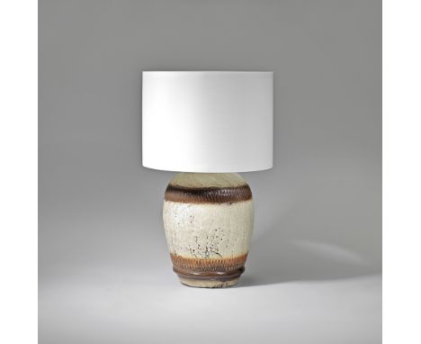 In the style of Jean BesnardTable lamp, circa 1930Glazed stoneware, fabric shade. 54.5 cm highUnderside with label printed 'M