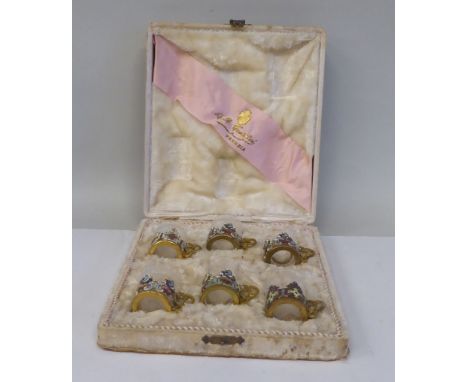 A set of six Venetian decoratively engraved, cylindrical tot glasses, set in coloured enamel and gilt metal frames with handl