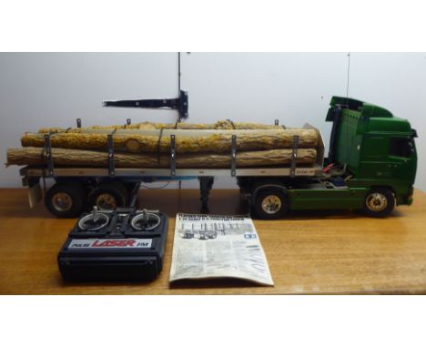A Tamiya 1:25 scale remote controlled model tractor tuck and trailer, decorated in green livery and scale legs&nbsp; 11.5"h&n