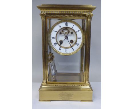 A late Victorian lacquered brass, four glass mantel clock with bevelled panels; the visible bell strike movement with a mercu