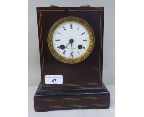 A late 19thC French part ebonised and string inlaid mantel clock of box design; the bell strike movement faced by a white ena