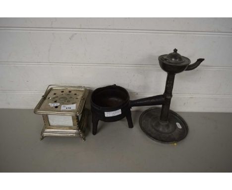 MIXED LOT COMPRISING AN 18TH CENTURY PEWTER OIL LAMP, A SMALL CAST IRON THREE FOOTED SKILLET AND A FURTHER TABLE WARMER (3)