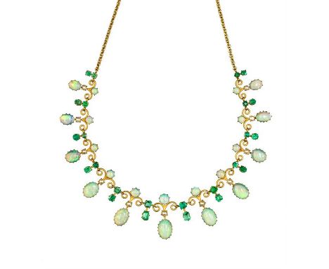 A Liberty & Co opal, emerald and seed pearl set fringe necklace, circa 1900, the yellow gold scroll work front comprising 11 