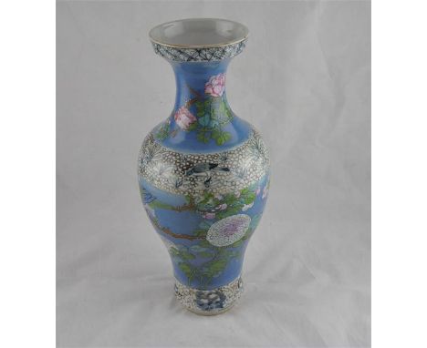 A Chinese 19th century, Qing period, blue ground roleau shape vase, decorated all round with flowering branches and birds,(Ex