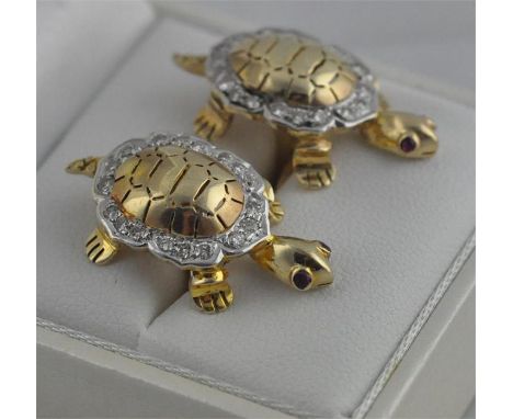 A pair of yellow metal and diamond "tortoise" cuff links,&nbsp;having domed shell with pierced decoration surrounded shaped w