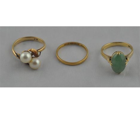 A 22ct. yellow gold band, hallmarked for 22ct. gold, (1.4g), together with a 14ct. yellow gold and jade ring, set ovoid caboc