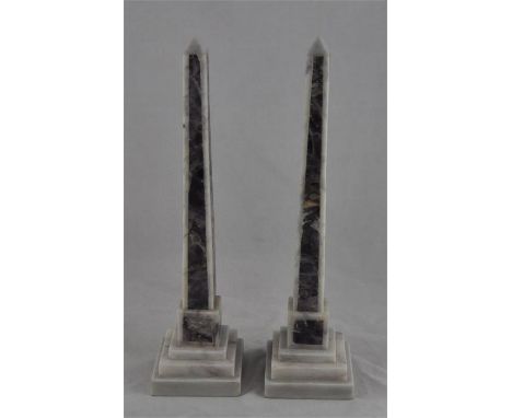 A pair of Grand Tour style polished marble obelisks, with amethyst coloured inserts, each on a stepped square base, 40cm high