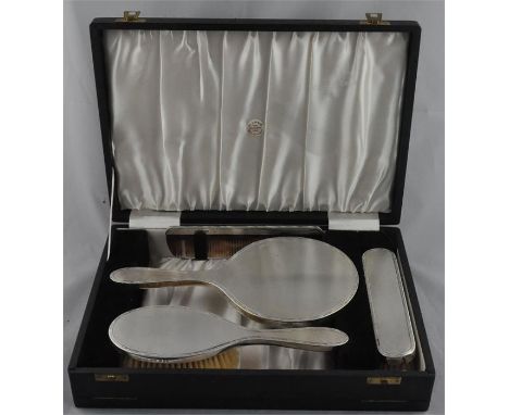 An Elizabeth II silver dressing table set,&nbsp;London 1961, comprising silver mounted mirror, hair brush, clothes brush and 