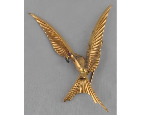 A gold "parrot" brooch, fashioned as a parrot taking flight, with ruby set eye, stamped foreign marks, gold assessed as 18 ca