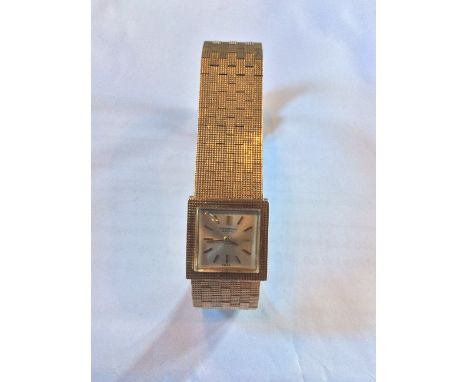An International Watch Co. 9ct. gold ladies' bracelet watch, manual movement, having silvered and raised gold baton square di