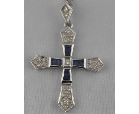 A 14ct. white gold, sapphire and diamond set crucifix, of traditional form, set calibre-cut sapphires and pave set diamonds, 