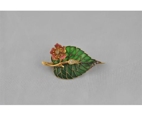 An 18ct. gold, diamond and enamel brooch, fashioned in the form of a leaf and open flower, the yellow gold leaf with green gl