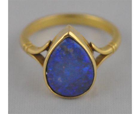 An 18ct. yellow gold and blue opal set ring, having tear drop shaped precious blue opal set in rub over mount, shank hallmark