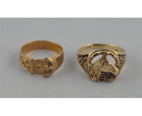 Two 9ct. gold rings, one a "buckle" ring, the other fashioned as a horses' head and gate framed within horseshoe,&nbsp;both h