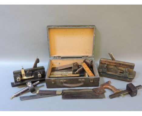 Twenty vintage woodworking tools, including an ebonised plough plane, three mortice gauges, seven brass topped spirit levels,