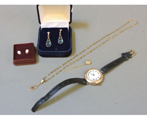 A pair of 9ct gold opal earrings, a 9ct gold single stone sapphire pendant and chain, a ladies 9ct gold mechanical strap watc