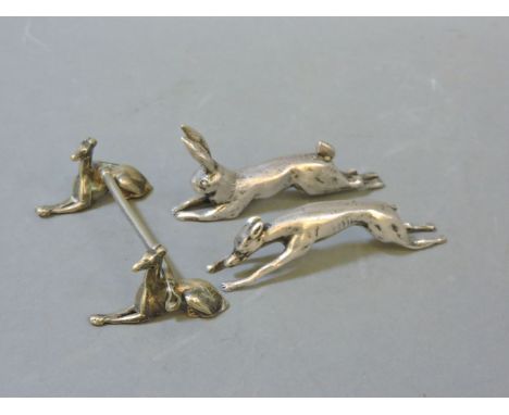 Three silver plated knife rests, a pair modelled as a hare and hound by W Hutton & Sons, and one as a pair of greyhounds