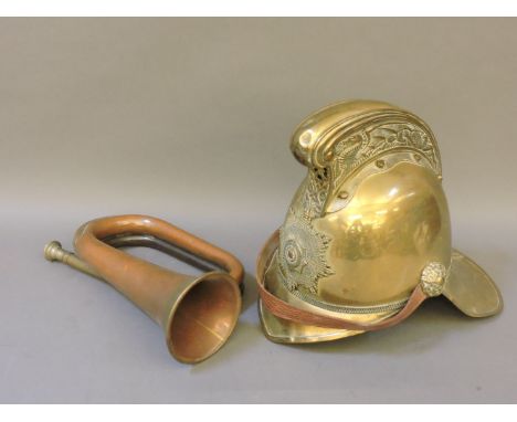 A brass fireman's helmet, and a copper bugle