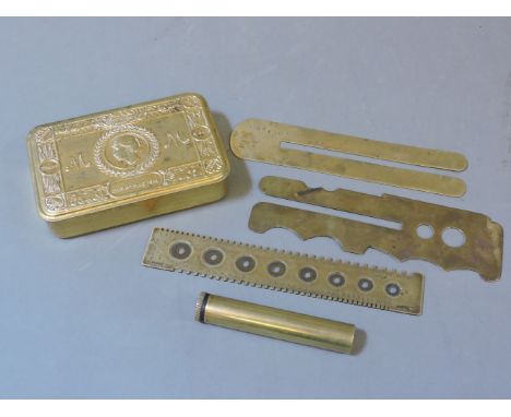 A Queen Mary brass gift tin, brass cartridge case measure, stamped W B & Co, two button polishers, and one further item